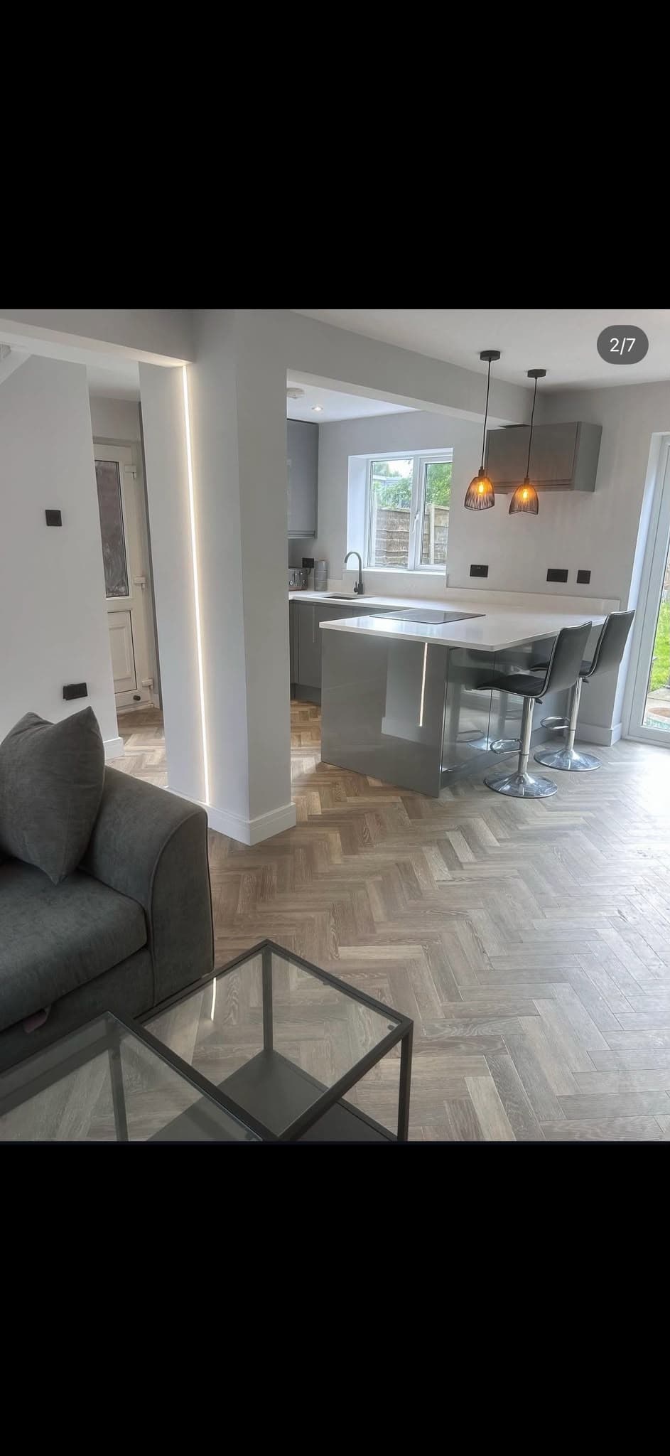 Completed LED strip and pendant lighting installation in a modern kitchen/living space